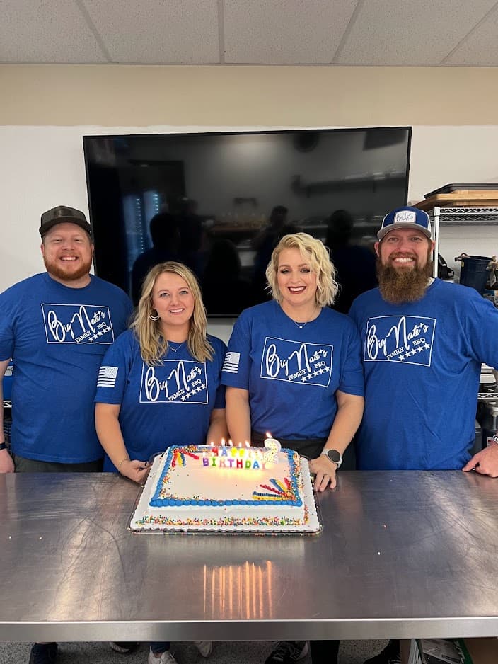 The Big Nate's Family BBQ team celebrating together in the kitchen